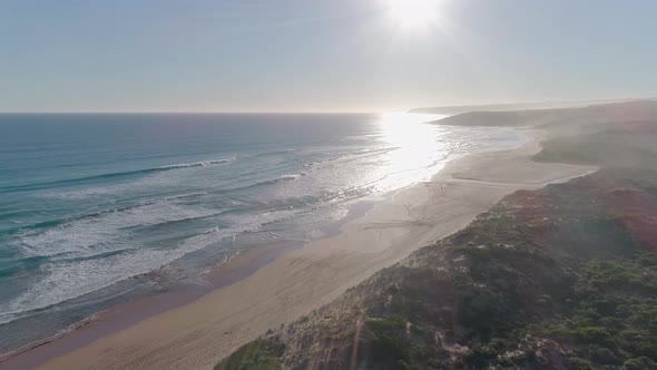 Aerial shot moving over a sandy beach and coastline in South Australia alt
