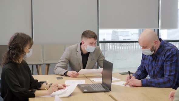 Business People Having a Meeting Working in the Office Wearing Medical Mask alt
