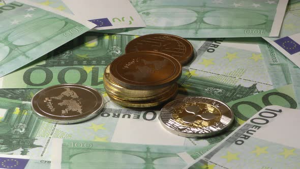 Ripple Coins Rotating on Bills of 100 Euro Banknotes. Worldwide Virtual Internet Cryptocurrency. alt