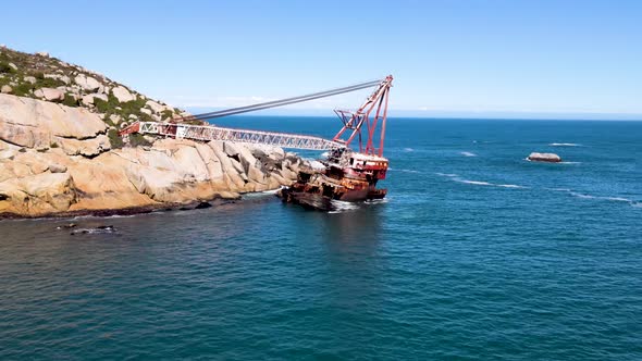 Aerial view of shipwreck crane barge is off the coast of Sandy Bay. alt