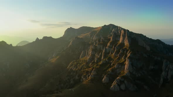 Drone view over Ciucas Peak at sunset, beautiful mountain scenery in Romania alt