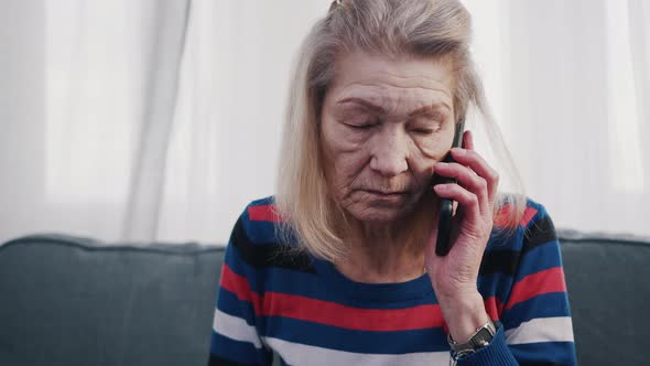 Elderly Woman Using Smartphone to Make Phone Call alt