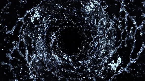 Super Slow Motion Shot of Rotating Water Splash Isolated on Black Background at 1000Fps alt