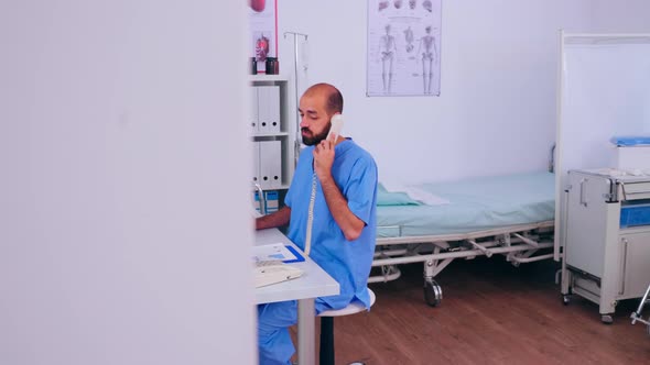 Woman Therapist Sitting at Workplace Looking at Laptop alt