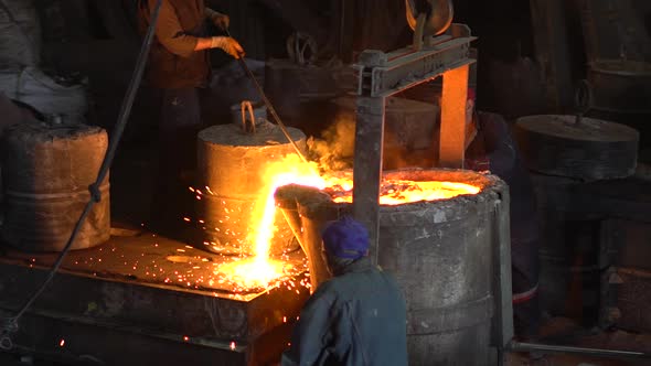 Pouring  Molten Iron Into Cast Mold