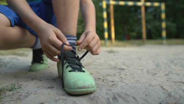 Boy Footballer Tying Shoelaces, Special Orthopedic Footwear for Sportsman