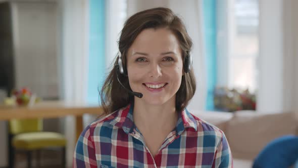 Happy Woman In Headset Making Video Call Communicating with Client Working From Home alt