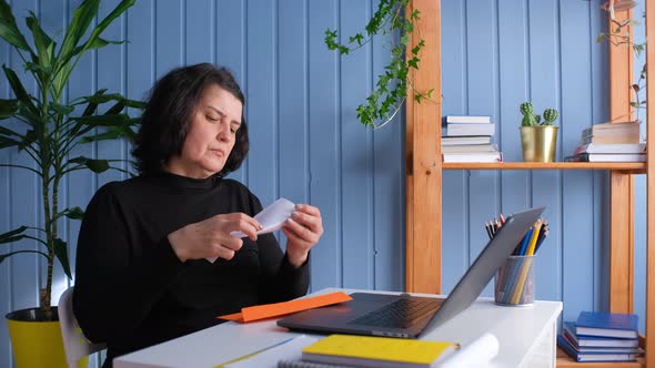 Middle Aged Woman Reading Document Paper Notice Letter