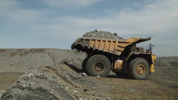 Multiton Dump Truck Lifts Body Unloads Waste Rock and Leaves