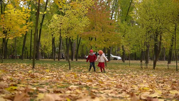 Two Happy Funny Children Kids Boy Girl Walking in Park Forest Enjoying Autumn Fall Nature Weather alt
