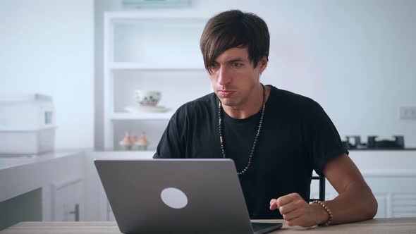 Angry Annoyed Man Screaming and Aggressively Reacting to What He Saw on Screen of Laptop Computer alt