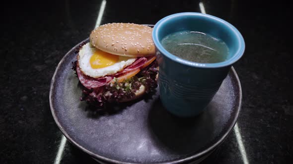 Sandwich with Fried Egg and Glass of Chicken Broth