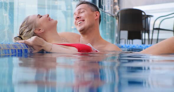 Young Woman with Fair Hair Bun in Pool Water By Coach alt