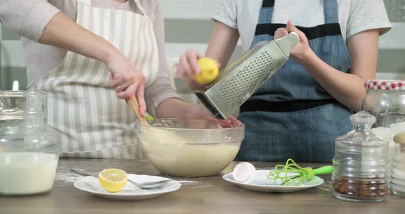 Hands of Mothers and Daughters Prepare Muffins, Knead the Dough with Tart Lemon Zest, Close Up alt