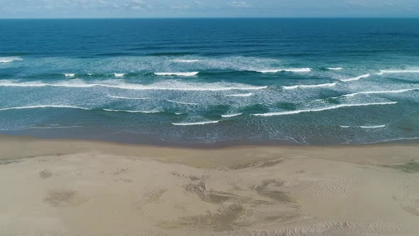 Aerial view of a pristine scenic sandy beach with breaking waves, South Africa alt