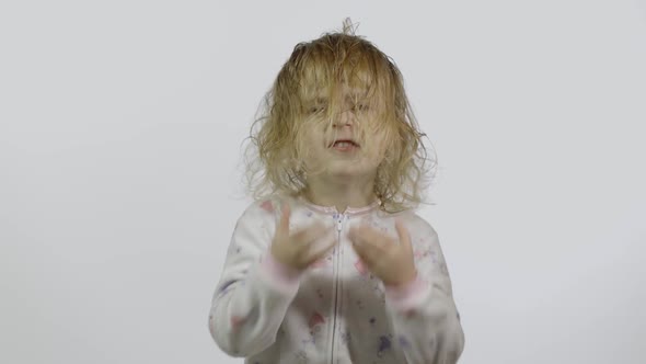 Little Baby Girl in Pajama Is Fooling Around and Make Faces. White Background alt