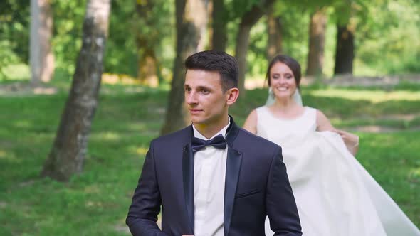 Newlyweds walk in the park. Bride Groom straddled like a horse. Slow motion alt