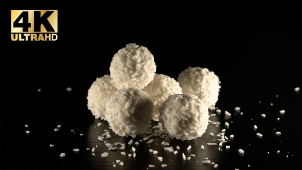  white chocolate candies in coconut flakes with almond 