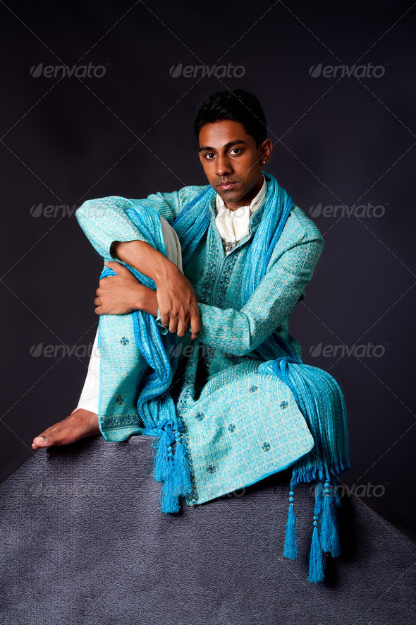 Hindu man sitting on rock - Stock Photo - Images