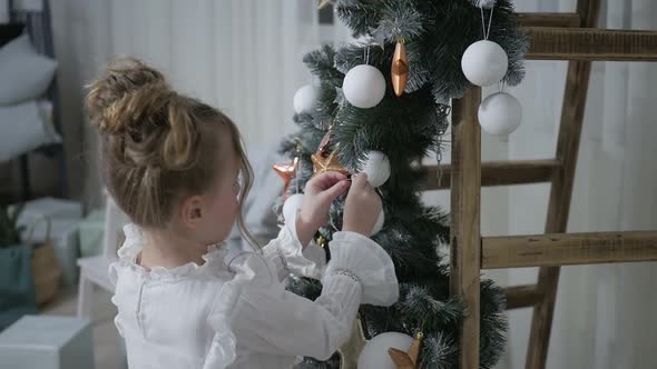 Happy American family celebrating Christmas. Children open a gift at home. alt