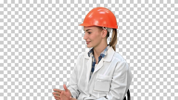 Female engineer in safety helmet sitting and talking, Alpha Channel