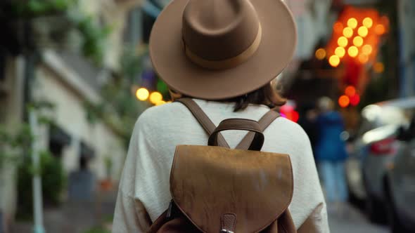 Attractive girl in a hat walking on a turkish street in Istanbul alt