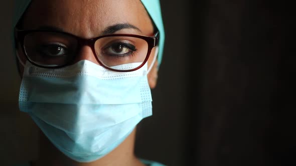 Young female medic, wearing a mask and glasses