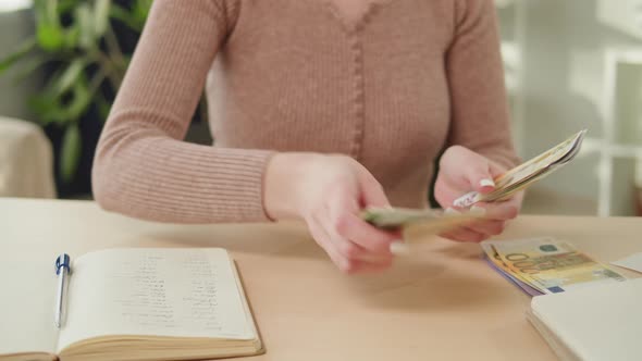 Housewife Counting Money for Monthly Expenses Rich Woman Holding a Stack of Euro in Hands alt