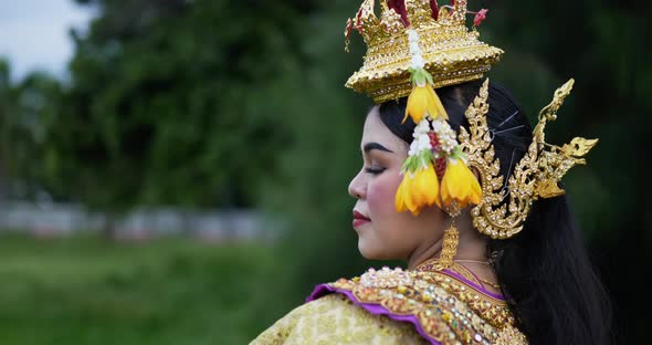 Thai woman in traditional dress looking at camera alt
