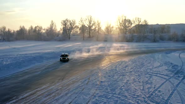 Slow Motion of a Car Drifting on a Winter Ice Road at Sunset