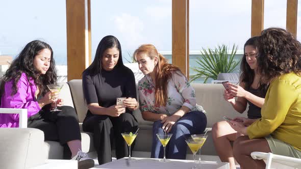 Group of Friends Having a Cocktail and Interacting with Mobile Phones