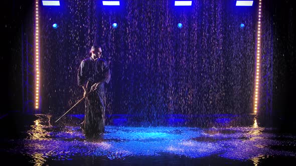 A Male Japanese Kendo Fighter Dressed in Traditional Kimono Practices a Martial Art with a Bamboo alt
