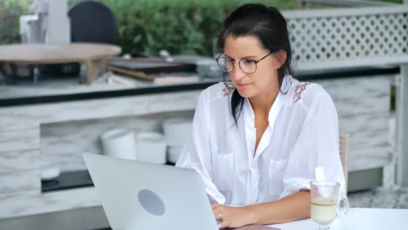 Young Attractive Casual Lady Enthusiastically Watching Using Digital Display Technology alt