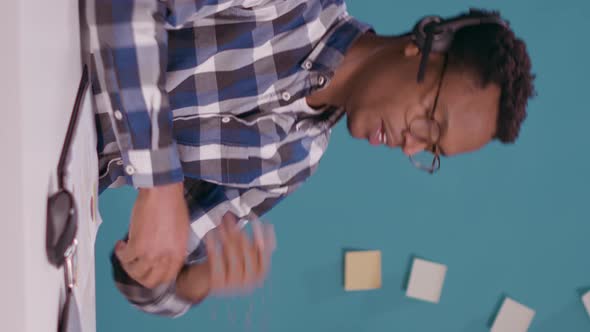 Vertical Video Young Man Talking with Client on Phone Call at Helpline Call Center alt