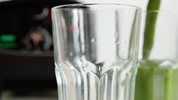 Pouring Green Smoothie in Glasses for Healthy and Nutrition Breakfast alt
