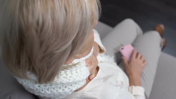 Old Woman in Scarf Holding Painful Throat and Calling Doctor, Health Problem