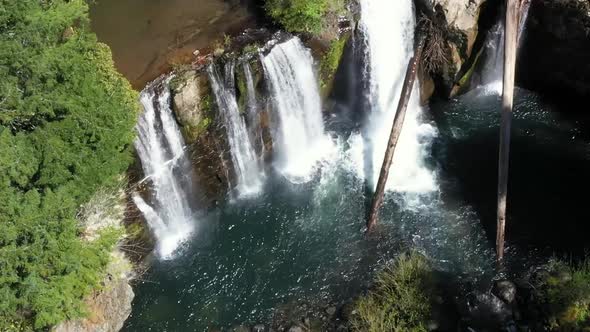 Drone footage, still, looking down at multiple water falls flowing at Coquille falls. Pristine clean alt