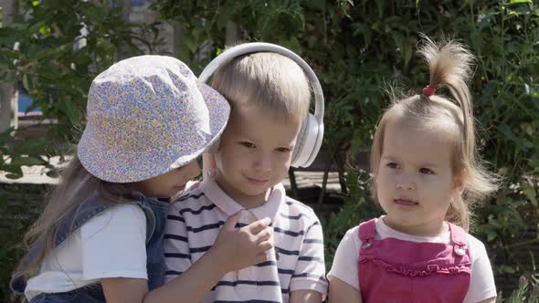 Portrait of Cute Little Three Children With Headphones Listening to Music