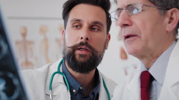 Handheld view of doctors talking about results of the radiology. Shot with RED helium camera in 8K alt