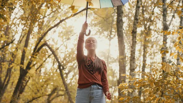 Girl Playing with Autumn Leaves in the Park alt