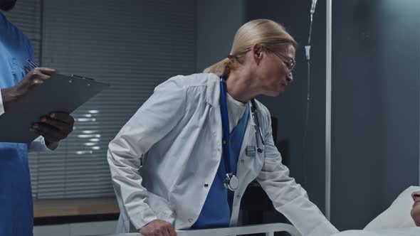 Nurse and Doctor Checking on Woman alt