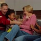 Excited School Age Multiracial Kids and Grandparents Having Fun Tickling on Sofa - VideoHive Item for Sale