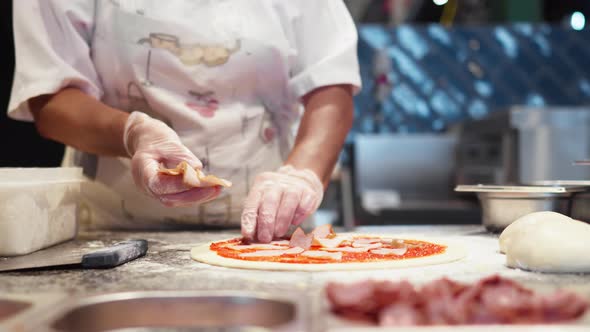 Chef Prepares Pizza Spreads Pieces Of Bacon On Raw Prepared Dough Dressing Preparing Pizza Baking alt