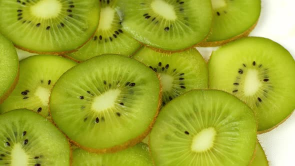 Top view Rotate of Transparent Slice of kiwi fruit on white background, Close up fresh kiwi sliced alt