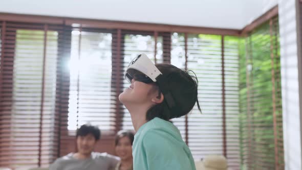 asian family son wear VR or virtual reality glasses