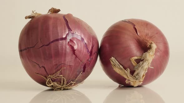 Pair of  onions with red skin and white flesh close-up 4K 2160p 30fps UltraHD tilting footage - Orga alt