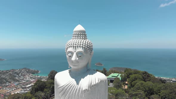 Majestic Big Buddha sitting atop Nakkerd Hill looking after Chalong in Phuket, Thailand  alt