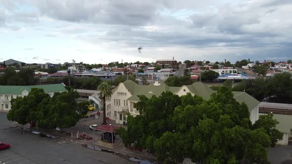 Drone footage of the Windhoek city in the morning, mountains on the horizon alt