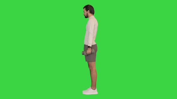 Handsome Guy Workout Exercising with Dumbbell on a Green Screen Chroma Key alt
