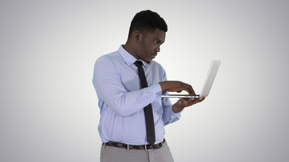 Afro American Business Man Working with Laptop on Gradient alt